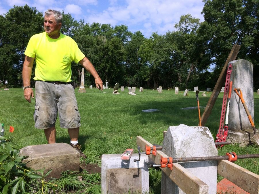John Heider, a cemetery preservationist, has been hired to repair and reset grave markers at Fort Hill Cemetery near Round Lake.